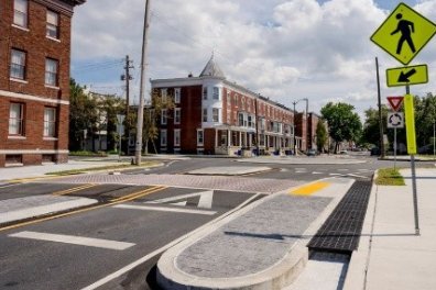 Raised crosswalk with a median island and pedestrian crossing sign