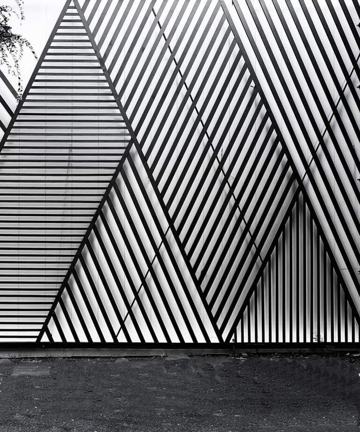 Black metal slats in diagonal stripes that form peaked, mountain-like shapes.